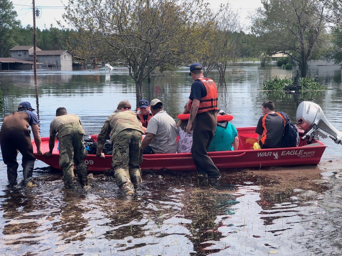 Coast Guard Shallow-Water Response Boat Team 3 crew members and members of the North Carolina National Guard assist residents of Old Dock, North Carolina, evacuate after flooding forced them from their homes September 17, 2018. The Coast Guard is conducting search and rescue operations in support of state and local emergency operation centers. (Coast Guard photo by Chief Petty Officer Stephen Kelly) Coast Guard Shallow-Water Response Boat Team 3 crew members and members of the North Carolina National Guard assist residents of Old Dock, North Carolina, evacuate after flooding forced them from their homes September 17, 2018. The Coast Guard is conducting search and rescue operations in support of state and local emergency operation centers. (Coast Guard photo by Chief Petty Officer Stephen Kelly)
